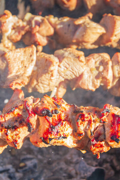 Fresh pork shish kebab is fried on skewers on the grill