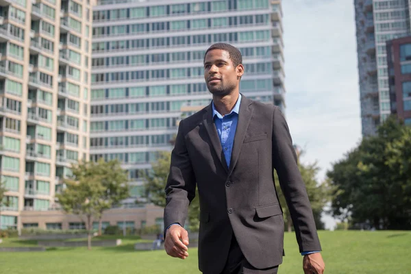 Modern African American business man in suits walking through th — Stock Photo, Image