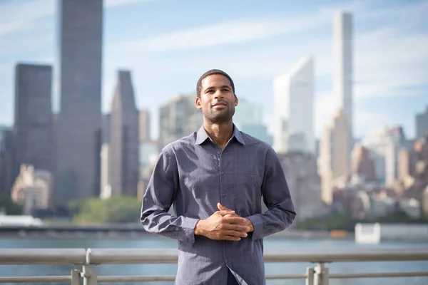 Portrait of young handsome African American man with NYC skyline — Stock Photo, Image