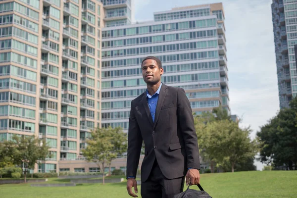 Young handsome African American man walking to work, looking sha — Stock Photo, Image