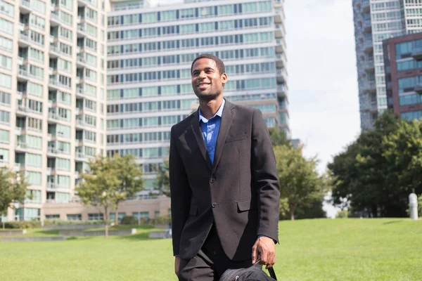 Young handsome African American man walking to work, looking con Stock Image