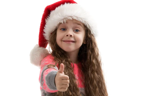 Счастливая маленькая девочка в костюме Новый год делает большие пальцы вверх — стоковое фото
