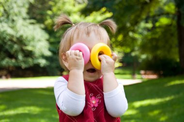 Küçük kız parkta eğleniyor.