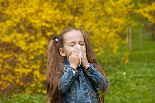 Flickan har en rinnande näsa. blommor pollenallergi. — Stockfoto