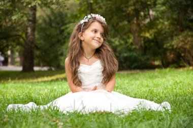 Küçük kız parkta eğleniyor.