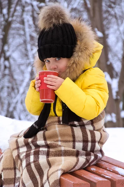 Μικρό κορίτσι χειμώνα στην οδό πίνοντας ζεστό τσάι. — Φωτογραφία Αρχείου