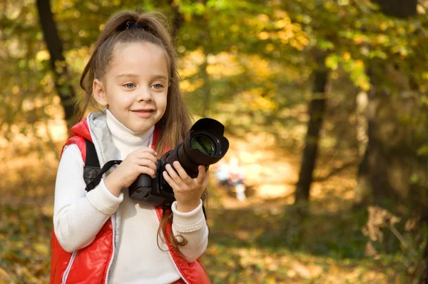 küçük kız bir kamera tutarak ve fotoğraf çekme. hobi.