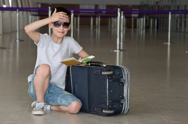 children with luggage in the airport.