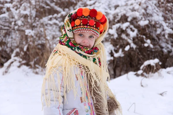 Kleines Mädchen im Winterwald. gekleidet in die ukrainische Nationalflagge — Stockfoto