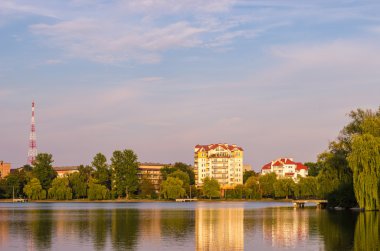 Güzel ev ayakta yakın zaman akşam kırsal kesimde göl.
