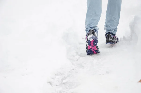 Men's shoes are on the mountain snowy footpath. Stock Picture