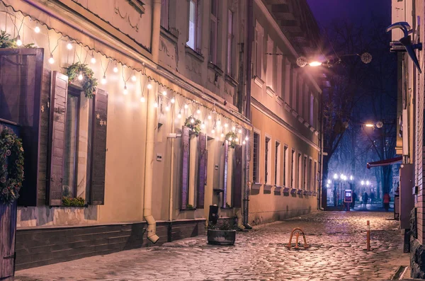 Old european town street cafe at night.