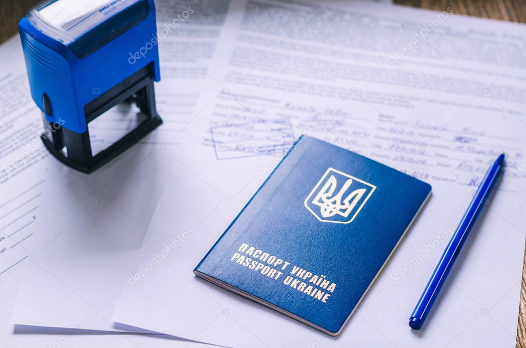 Ukrainian passport with documents and stamps.