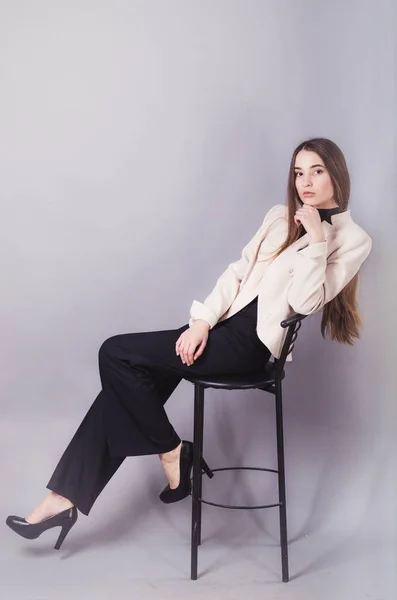 stock image Beautiful woman in black clothes posing for the camera portrait young studio on gray.