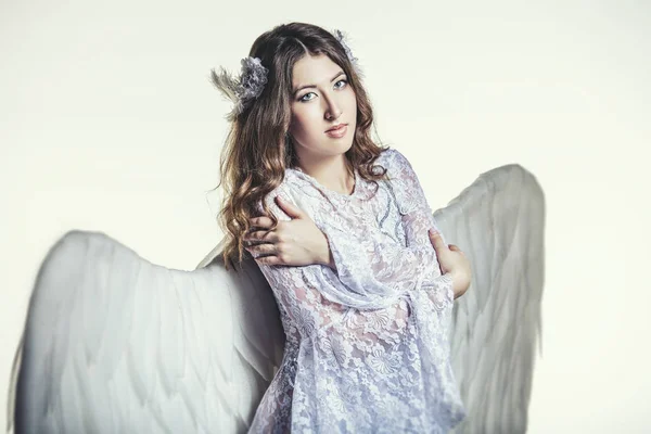 Woman angel with white wings costume in a religious