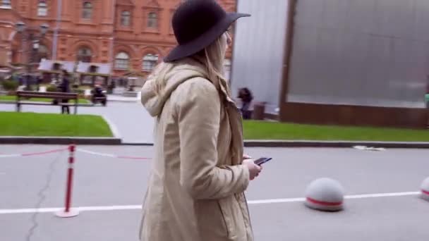 Moskou, Rusland, 24.07.2016: Jonge vrouw lopen in Moskou de straat, met brede rand hoed — Stockvideo