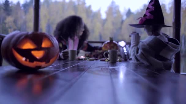 Two teen girls sharing candys after trick or treat on Halloween — Stock Video