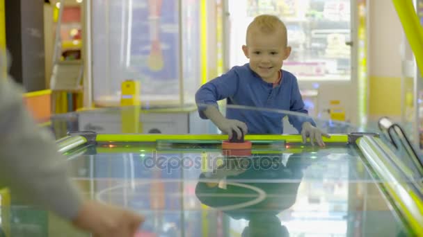 Little boy plaiying air hockey — Stock Video