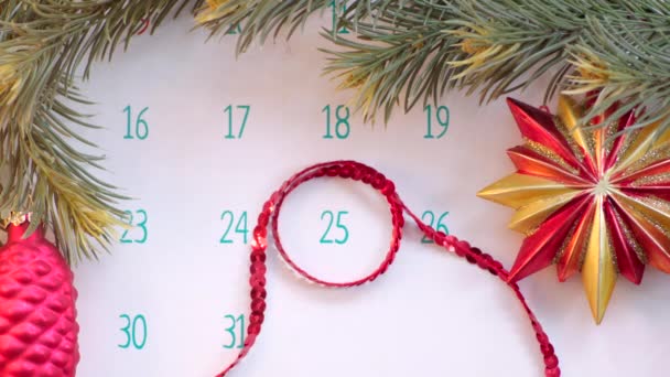 Christmas day on calendar page with holiday decoration — Stock Video