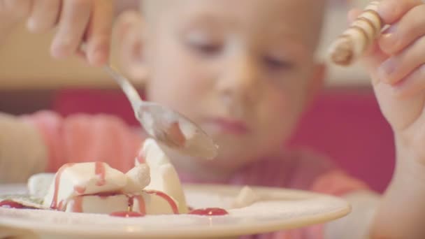 Крупный план маленького мальчика, наслаждающегося мороженым — стоковое видео