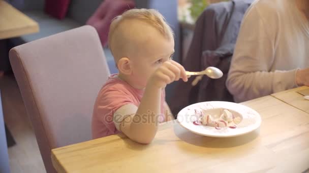 Közelkép a kisfiú eszik fagylaltot, kanállal — Stock videók