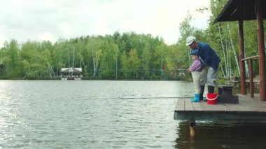 Küçük bir çocuk ve onun dedesi Fishing