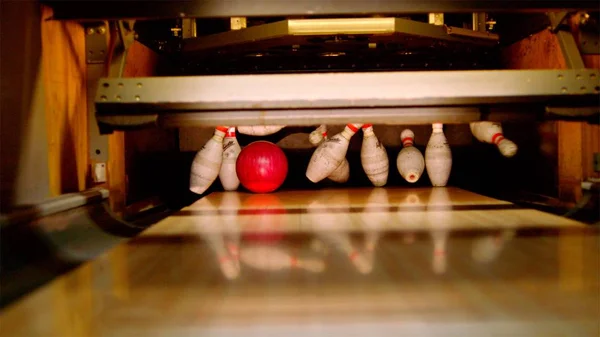 Bowling ball knocking all pins down. Strike