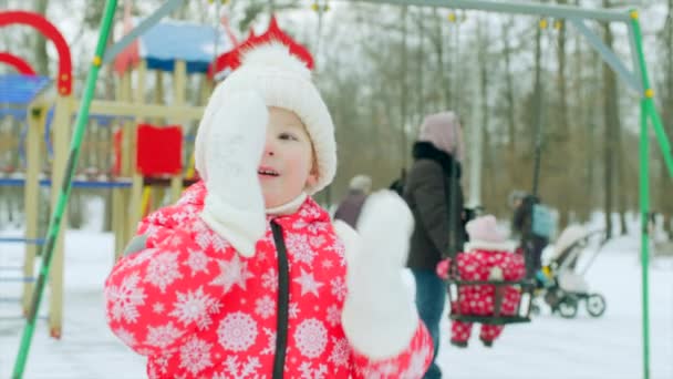 Little boy is coughing on the playground in winter — Stock Video