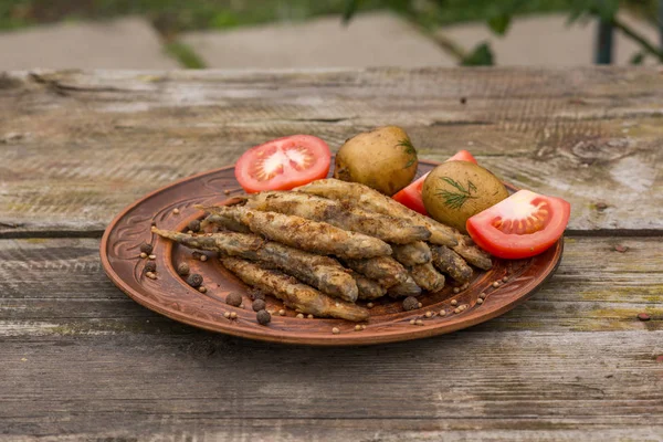 De kleine vis gebakken op de rustieke houten tafel — Stockfoto