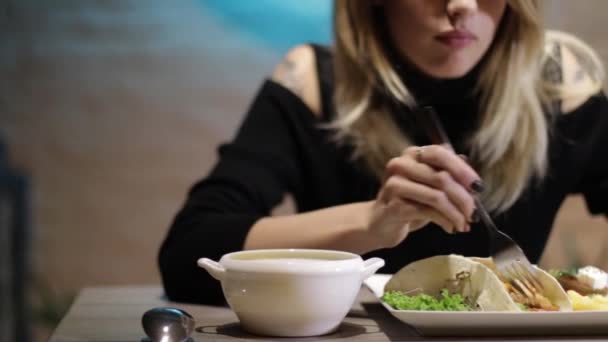Pretty Girl Eats Food Restaurant — Stock Video