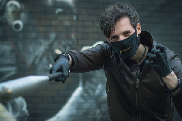 masked guy with a baseball bat in his hands