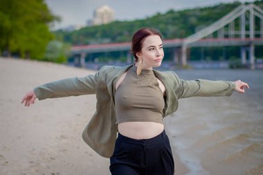 Yakın plan moda kadın portresi. Plajda poz veren güzel moda kızı. Plajda şık, esmer bir kadın.