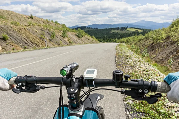 Close up bicycle rider's hands on a  bicycle handlebar. — Stock Photo, Image