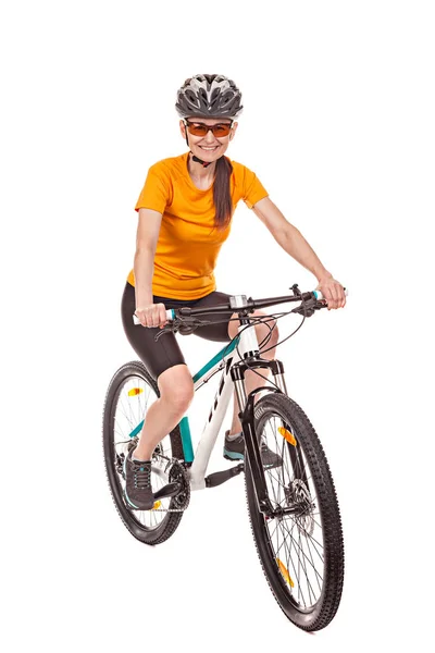 Attractive adult woman cyclist, riding a bike, looking at the ca — Stock Photo, Image