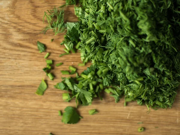 Finely chopped greens on a chopping board. — Stock Photo, Image