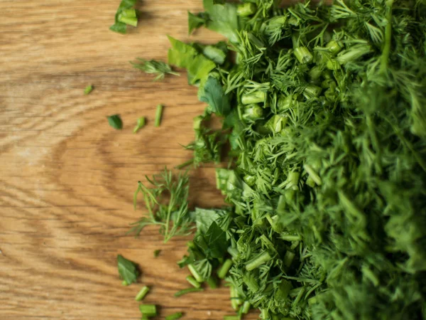 Finely chopped greens on a chopping board. — Stock Photo, Image