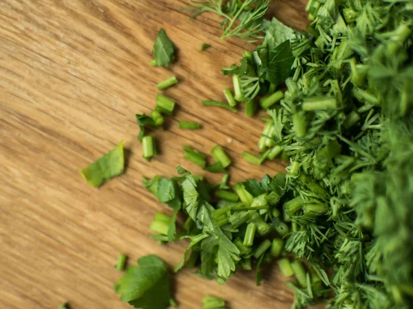 Finely chopped greens on a chopping board. — Stock Photo, Image