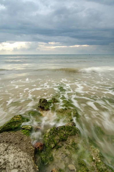 Hermosa ola blanca y suave fluyen sobre la roca y musgoso golpeando la orilla —  Fotos de Stock