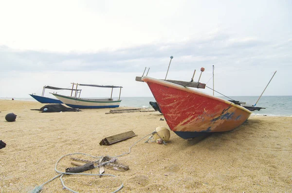 Stängt upp fiskare båt strandsatta på sandstranden och molnig himmel — Stockfoto