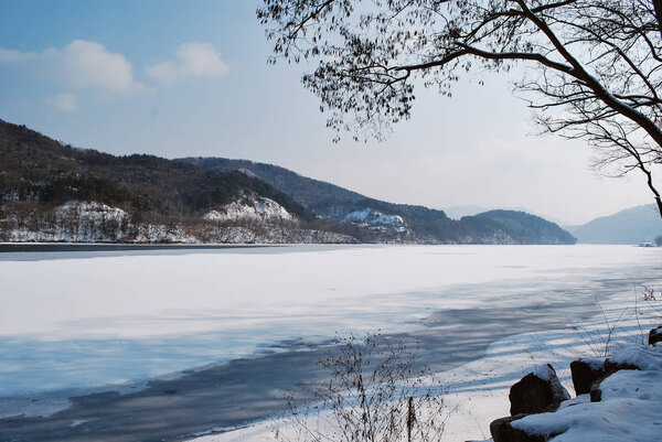 Beautiful nature,park covered by snow and freezing lake during winter