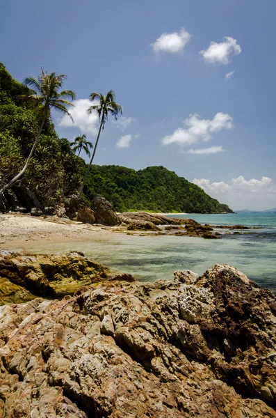 Hidden beauty nature of Kapas Island located in Malaysia, magical rock formation over blue sky background