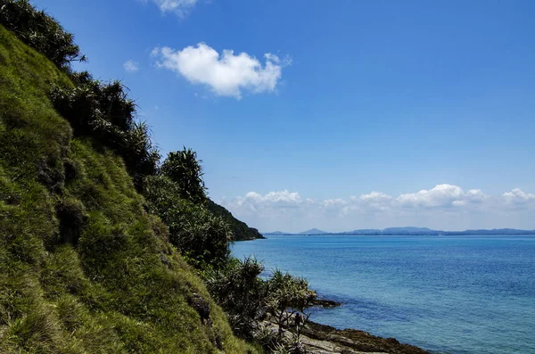 Hidden beauty nature of Kapas Island located in Malaysia, magical rock formation over blue sky background