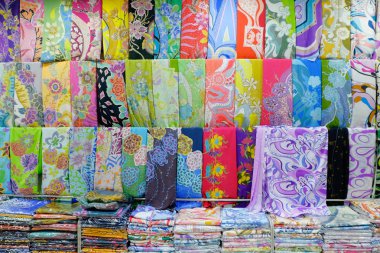 TERENGGANU, MALAYSIA-FEBRUARY 2017: Variety of beautiful silk fabric display at Pasar Payang, most popular textile and batik bazzar located at East Malaysia clipart
