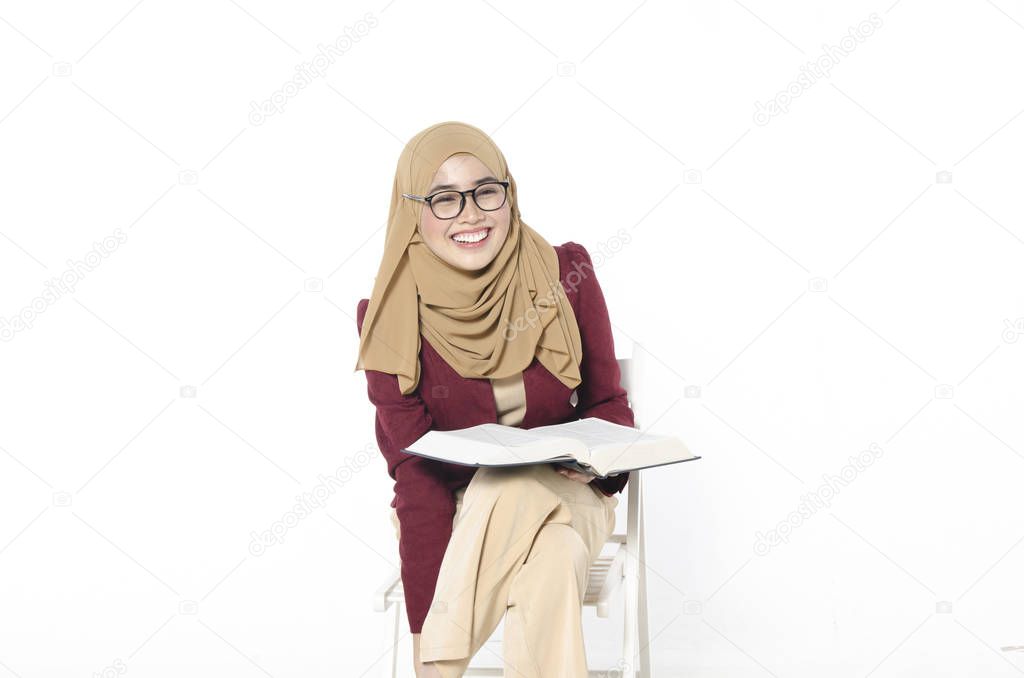 young university student sitting and holding book