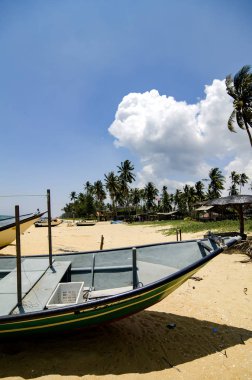 Güzellik doğada, parlak güneşli bir günde ve mavi gökyüzü altında ıssız kum plajındaki mahsur balıkçı teknesi 