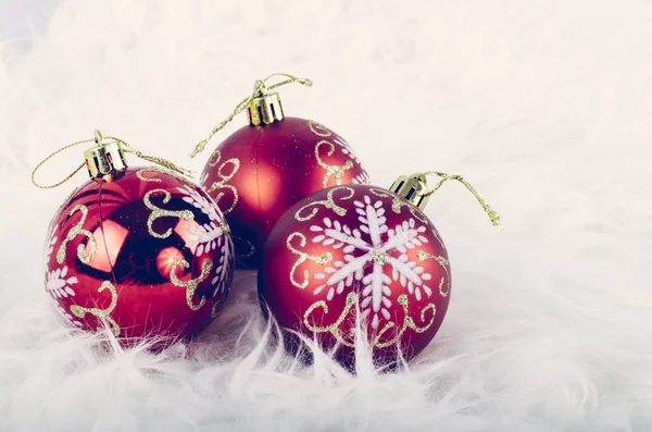 Christmas festival decoration with red ornament ball on fluffy white mat