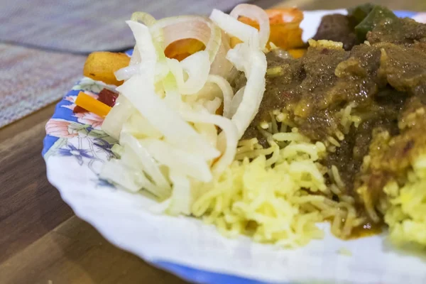 Malaysian East cost famous yellow rice served with pineapple salad and beef stew
