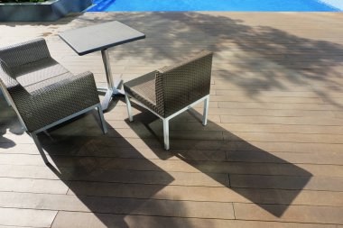 sandalye ve masa yan havuzun seyahat ve tatil concept.bright güneşli gün ve ahşap platform üzerine gölge için ideal oteller