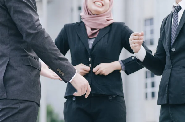 Group of young executive people in formalwear discussing something and gesturing