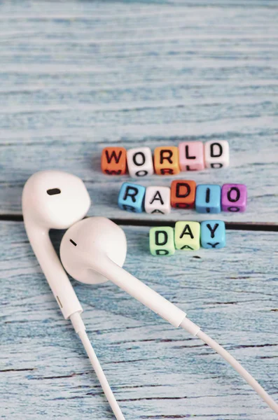 colorful World Radio Day word cube on wooden background